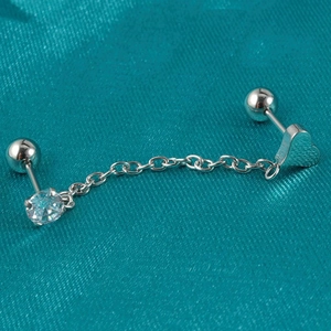 Macro view of stainless steel chain earrings featuring zircon studs and heart charm detail