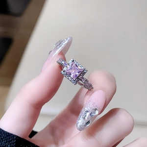 Close-up of luxury halo ring featuring square pink zircon and shimmering side stones