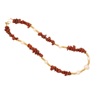 Handmade necklace with red stones, white pearls, and gold beads on white background