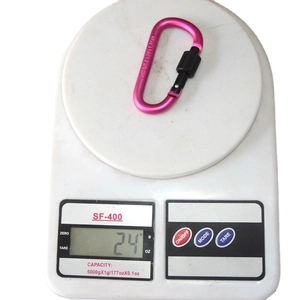 Pink D-ring aluminum carabiner with screw lock shown on scale weighing 24g