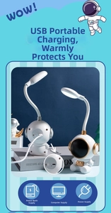 Detailed view of astronaut LED lamp USB charging port and versatile power connection options