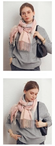 Detail of pink and grey color-block scarf with tassels on soft cashmere-like fabric