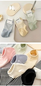 Detail of combed cotton striped low-cut socks in cream colors with comfortable wide cuffs