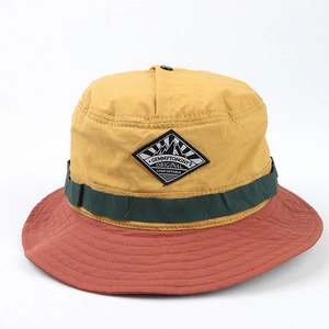 Detail of color-block sun hat showing yellow, green, and red panels with brand patch