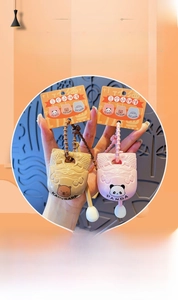 Close-up of cute Panda and Capybara stress-relief wooden fish keychain pendants