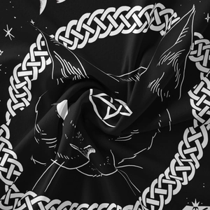 Detailed view of woven fabric texture with celestial cat moon and sun patterns