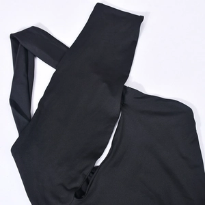 Close-up of black bodycon dress featuring hollow-out neck detail and elastic fabric