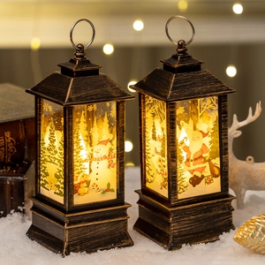 Vintage bronze Christmas LED lanterns with Santa and Snowman motifs in a snow scene
