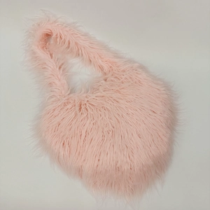 Close-up of pink faux fur heart-shaped bag showing soft plush texture and detail