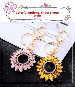 Detail of sunflower crystal keychains with rhinestones and white pearl pendant charms