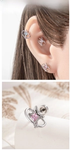 Macro detail of star and planet piercings with colored gemstones and screw back design