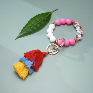 Close-up of colorful silicone beaded keychain with a vibrant triple-layer tassel