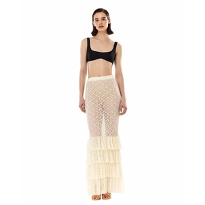 Detail of beige lace mermaid skirt with layered ruffles and sheer mesh texture