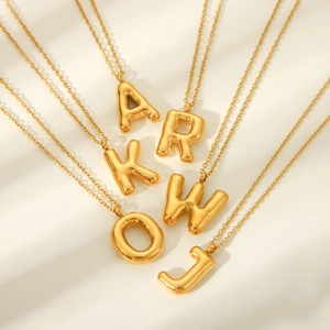 Golden 3D puffy bubble letter necklaces in metallic balloon style on white background