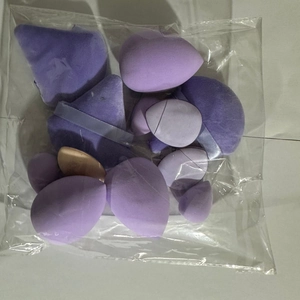 Close-up of a 12-piece purple and beige mini makeup sponge set in transparent packaging