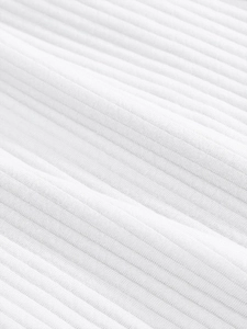 Macro detail of high-quality white corduroy fabric texture with vertical ribbed pattern