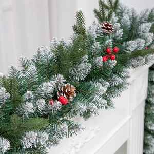 9FT Christmas garland with snowy flocked pine needles, red berries and pinecones on fireplace