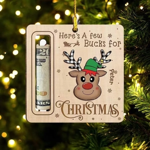 Close-up of wooden reindeer money holder ornament with custom text on Christmas tree