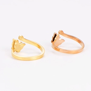 Macro view of gold and rose gold butterfly rings with textured matte finish and crystals