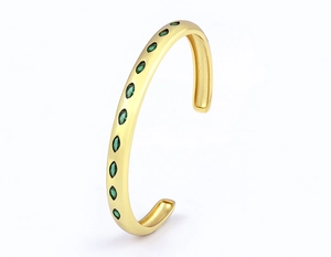 Detail of 18k gold plated C-shape open bracelet featuring green marquise-cut zircons