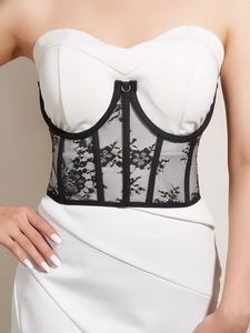 Detail of white tube top dress featuring a black lace corset belt with boning structure