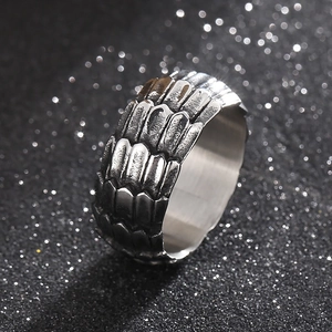 Macro detail of punk style silver dragon scale ring with vintage distressed metal texture