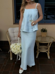 Detail of light blue linen two-piece set featuring camisole top and long fishtail skirt