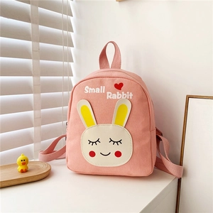 Detailed view of pink canvas toddler backpack with cute rabbit print and top handle