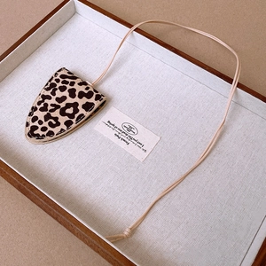 Detailed view of leopard print faux leather glasses case necklace with fine stitching