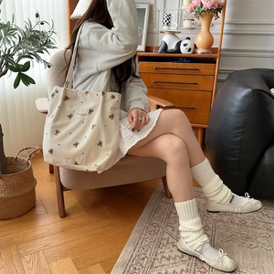 Cozy corduroy tote bag with bear print shown in a vintage indoor lifestyle setting