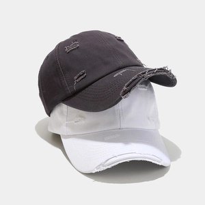 Distressed vintage baseball caps in grey and white with torn edges and worn-out style