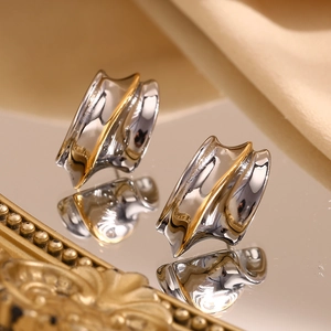 Minimalist 18K gold-plated stainless steel knight helmet stud earrings on a mirror