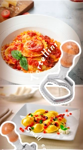 Macro view of pasta cutter tool next to professional plates of fresh tortellini pasta