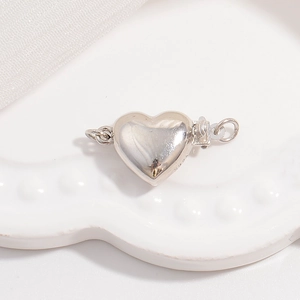 Macro detail of S925 sterling silver heart-shaped jewelry clasp for bracelets