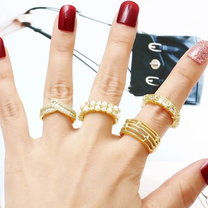 Double layered 18k gold plated pearl and zircon rings on female model fingers
