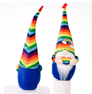 Detail of colorful rainbow gnomes featuring striped hats and plush blue fabric bodies