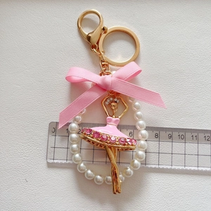 Detailed view of rhinestone ballet girl keychain showing total length of 11cm on a ruler