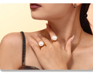 Close-up of 18K gold-plated titanium steel ring featuring a large white shell pearl on model