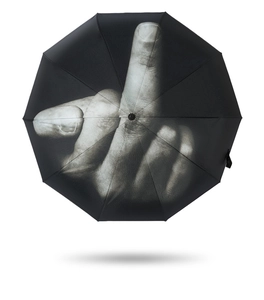Detail shot of black folding umbrella featuring a bold middle finger gesture print