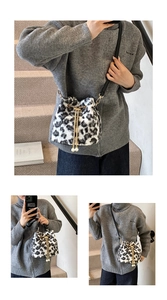 Detail of leopard print faux fur bucket bag with pearl charms and golden chain drawstring