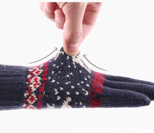 Detail of navy blue Nordic pattern knitted gloves showing elastic wrist stretch with arrow