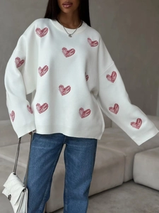 Oversized white knit sweater for women with red heart patterns and crew neck design