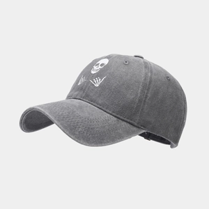 Detail of grey washed cotton baseball cap with skull and hand gesture graphic
