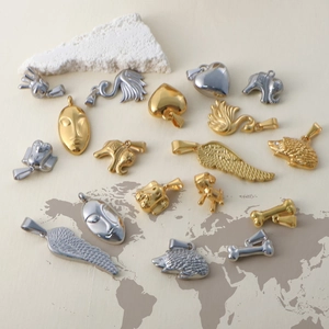 Detailed close-up of mixed vintage stainless steel pendants in gold and silver plating