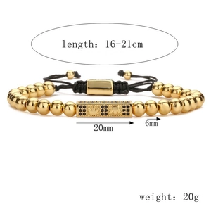Detail of adjustable braided bracelet with gold beads and black gemstone rectangle charm