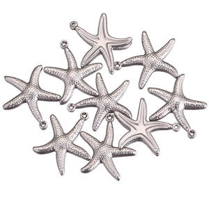 Macro shot of silver stainless steel starfish pendants with textured surface and ring loop