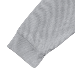 Detail of grey waffle knit fabric texture and sleeve cuff on men's long sleeve henley shirt