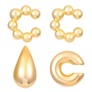 Detailed view of four golden minimalist C-shaped and teardrop-textured ear cuffs set