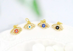 Macro view of 18K gold plated evil eye pendants with micro-pave zircons and enamel