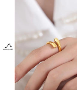 Detailed view of dual-layer gold stainless steel ring worn with elegant pearl accents